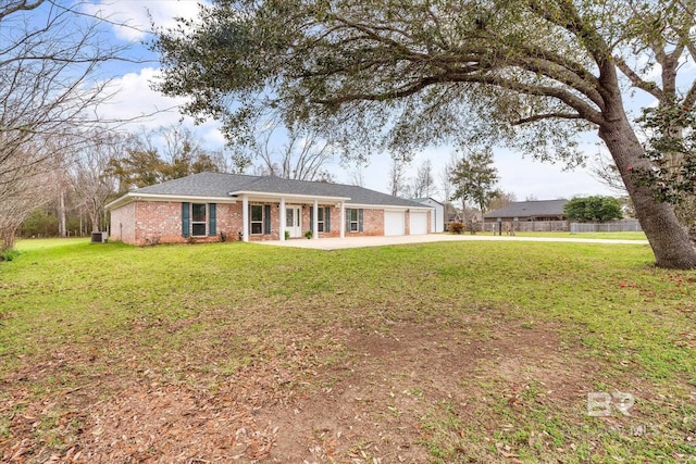 ranch-style home featuring brick siding, a front lawn, covered porch, driveway, and an attached garage