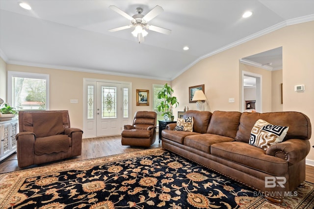 living area featuring a ceiling fan, wood finished floors, recessed lighting, ornamental molding, and vaulted ceiling