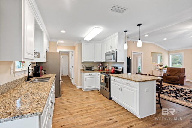 kitchen with visible vents, ornamental molding, appliances with stainless steel finishes, white cabinetry, and a sink