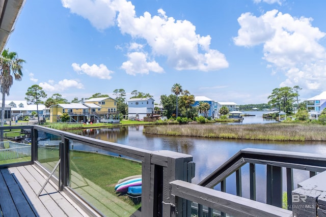 dock area with a water view and a balcony