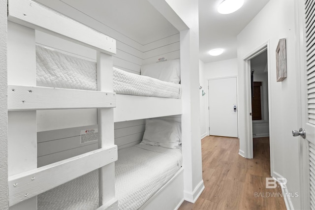 bedroom featuring baseboards and wood finished floors