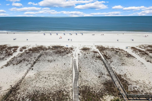 birds eye view of property featuring a beach view and a water view