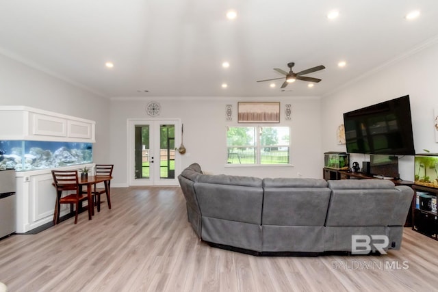 living area with recessed lighting, a ceiling fan, light wood finished floors, french doors, and crown molding