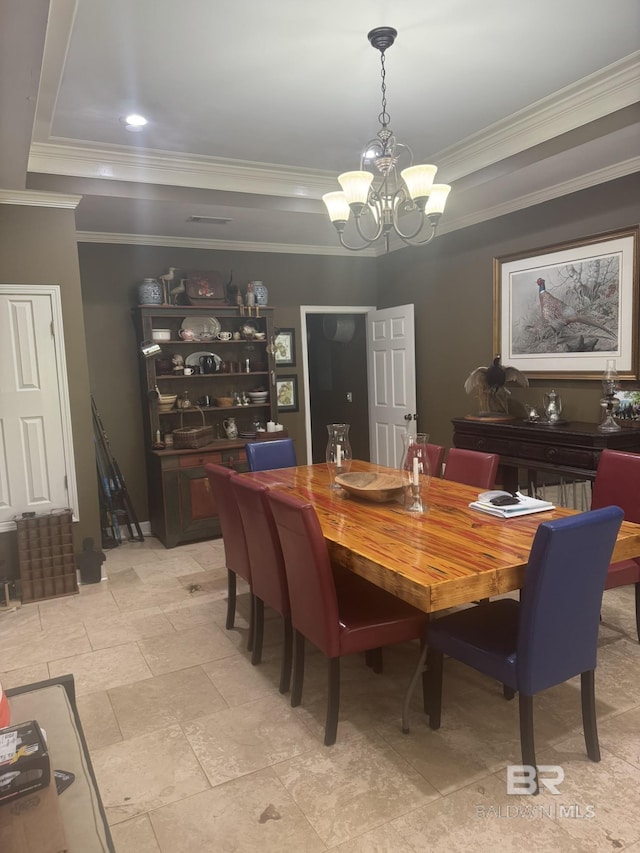 32098 Jessup Ln, Lillian, AL 36549 - dining space with a raised ceiling, a chandelier, and ornamental molding