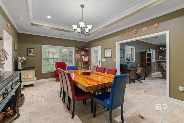 32098 Jessup Ln, Lillian, AL 36549 - dining room with a chandelier, crown molding, a raised ceiling, and baseboards