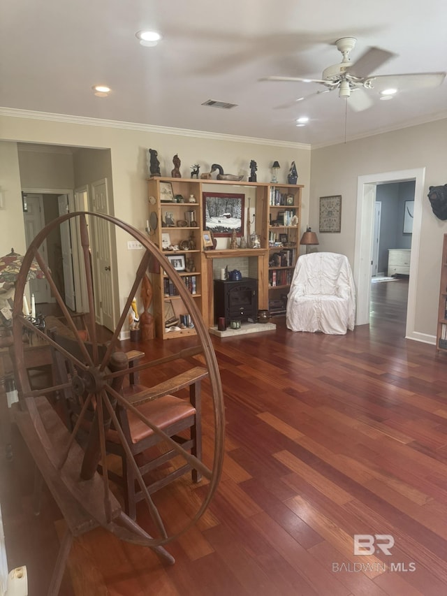 32098 Jessup Ln, Lillian, AL 36549 - living room with a wood stove, a ceiling fan, crown molding, wood finished floors, and recessed lighting