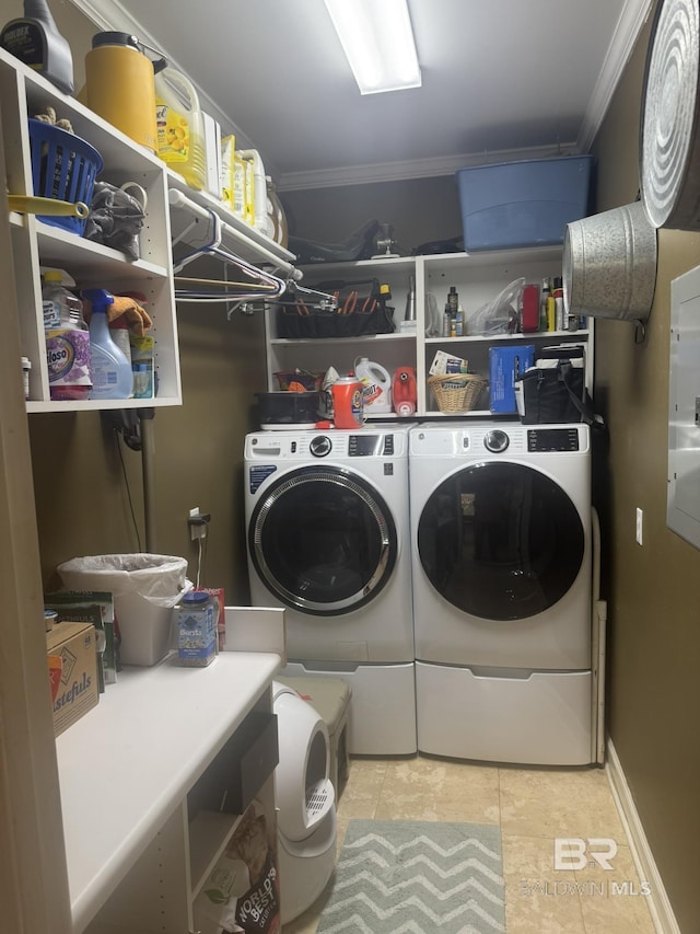 32098 Jessup Ln, Lillian, AL 36549 - laundry area featuring washing machine and dryer, crown molding, and tile patterned flooring