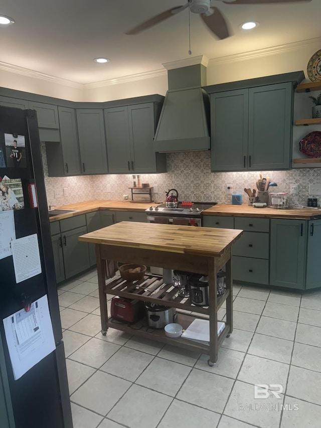 32098 Jessup Ln, Lillian, AL 36549 - kitchen featuring freestanding refrigerator, premium range hood, green cabinetry, a ceiling fan, and crown molding