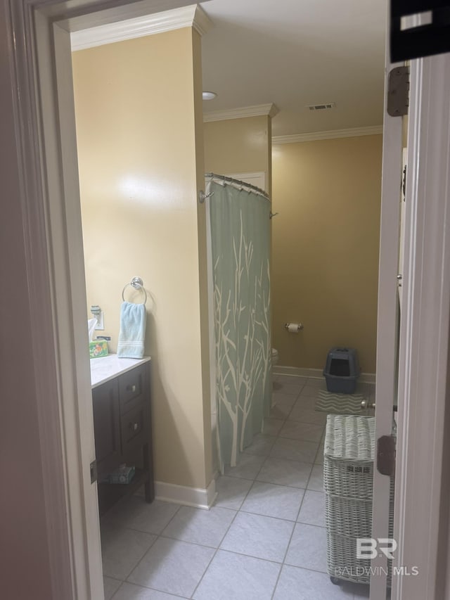 32098 Jessup Ln, Lillian, AL 36549 - full bathroom with ornamental molding, tile patterned flooring, baseboards, vanity, and toilet