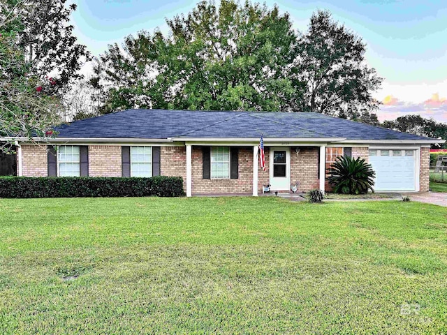 single story home with a garage and a lawn