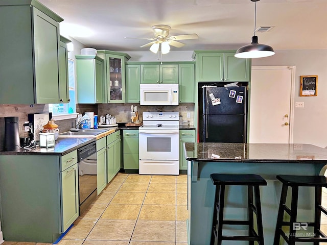 kitchen with white appliances, green cabinetry, a sink, a ceiling fan, and backsplash