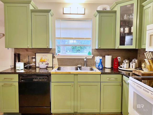 kitchen featuring white appliances, green cabinetry, a sink, and tasteful backsplash