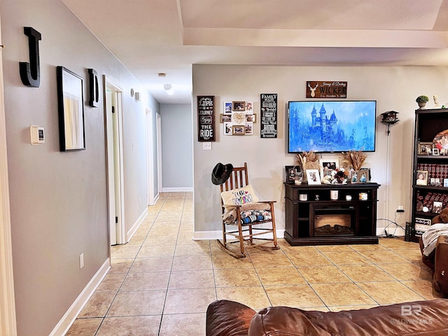 living room with tile patterned floors and baseboards
