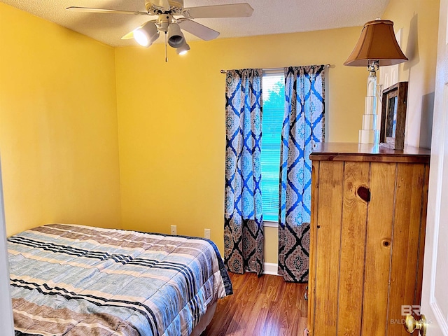 bedroom with wood-type flooring and ceiling fan