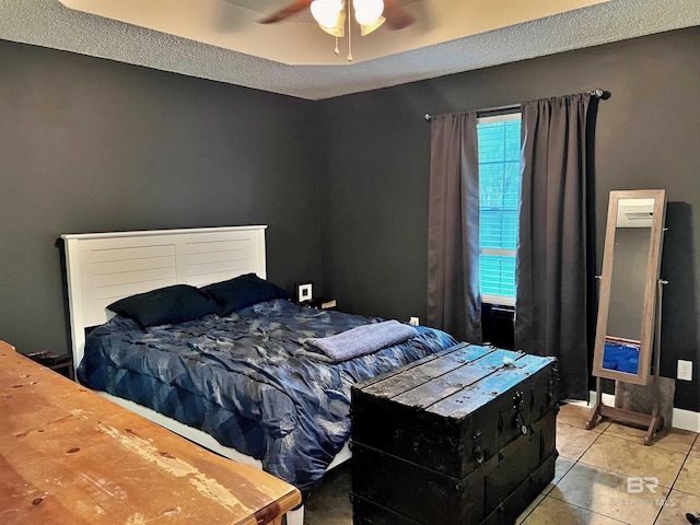 tiled bedroom featuring ceiling fan