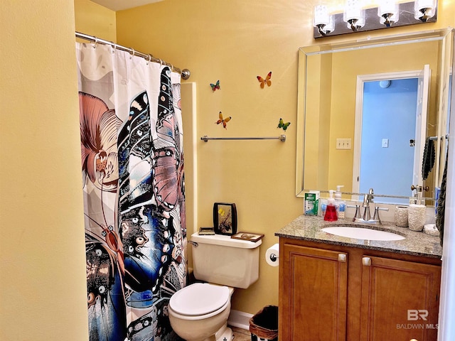 bathroom featuring vanity, toilet, and a shower with shower curtain