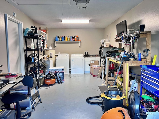 garage featuring washing machine and clothes dryer and a workshop area