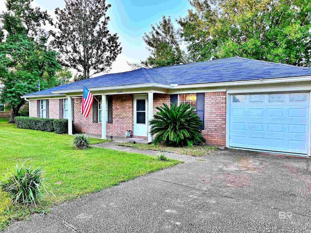 single story home with a garage and a front lawn