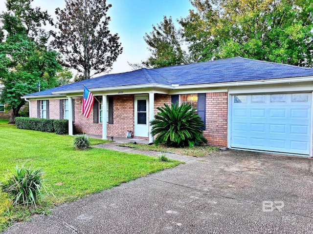 ranch-style home with brick siding, an attached garage, a front yard, driveway, and roof with shingles