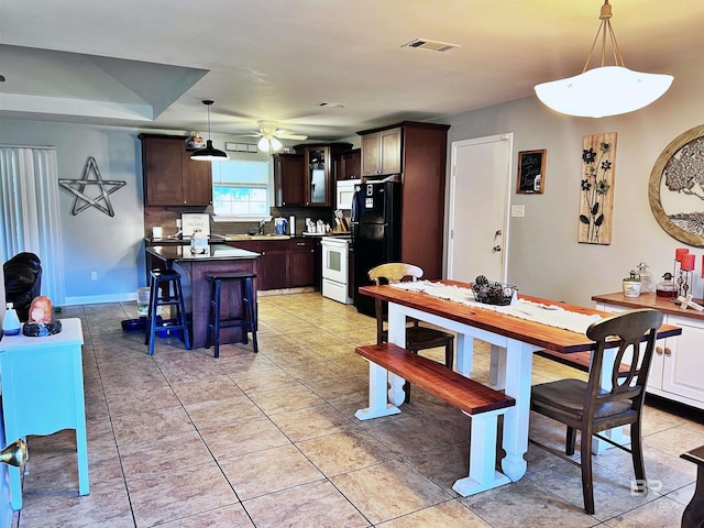 dining space with sink, ceiling fan, and light tile patterned flooring