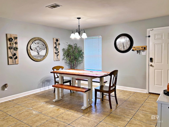 dining room with light tile patterned flooring, baseboards, and a chandelier