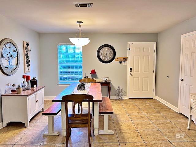 dining space featuring light tile patterned floors