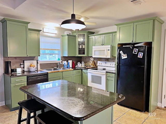 kitchen with black appliances, green cabinetry, a sink, and backsplash