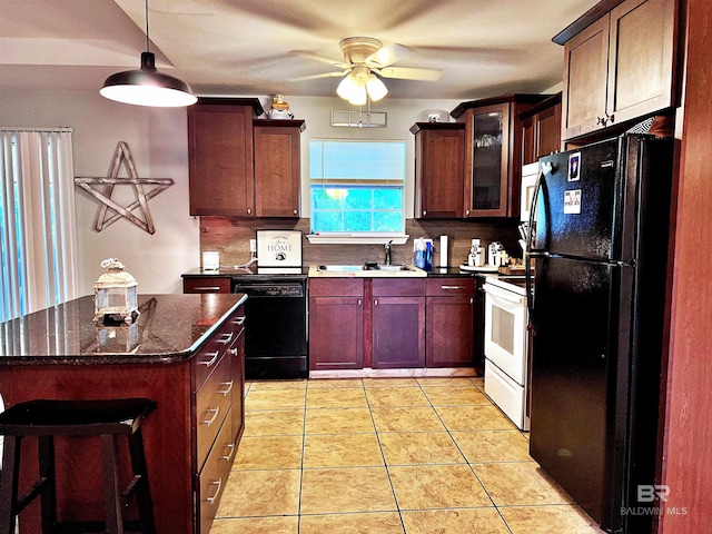 kitchen with sink, dark stone countertops, backsplash, light tile patterned floors, and black appliances