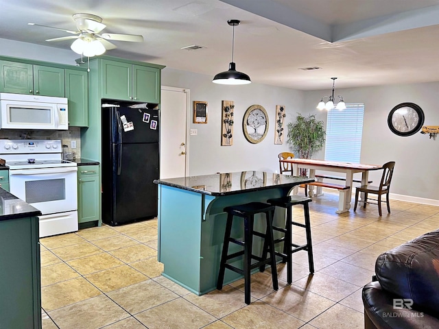 kitchen featuring white appliances, green cabinets, ceiling fan, and light tile patterned floors