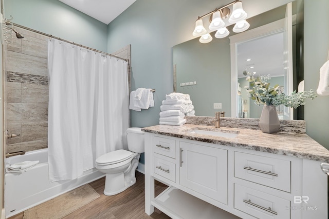 bathroom featuring shower / tub combo with curtain, vanity, toilet, and wood finished floors