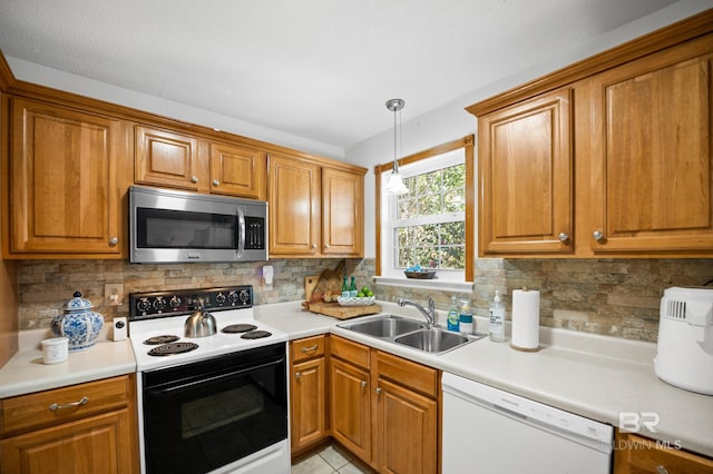 30577 Baldwin St, Perdido Beach, AL 36530 - kitchen featuring stainless steel microwave, electric stove, white dishwasher, a sink, and brown cabinets