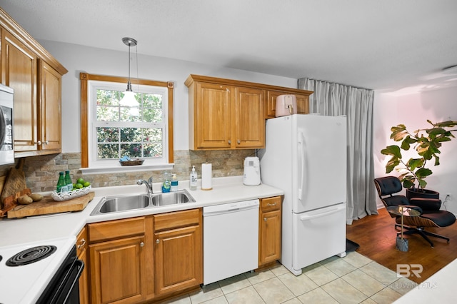 30577 Baldwin St, Perdido Beach, AL 36530 - kitchen featuring white appliances, a sink, light tile patterned floors, and light countertops
