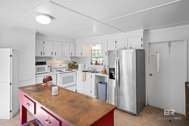 30577 Baldwin St, Perdido Beach, AL 36530 - kitchen featuring white appliances, under cabinet range hood, white cabinetry, and light wood-style floors