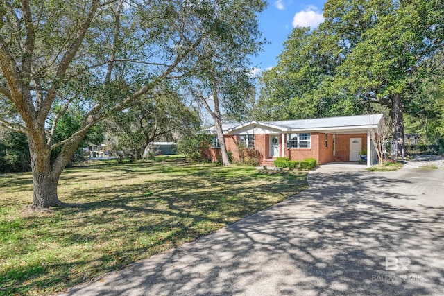 30577 Baldwin St, Perdido Beach, AL 36530 - single story home with driveway, a front yard, brick siding, and an attached carport