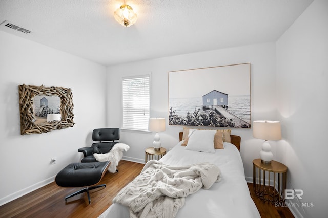 30577 Baldwin St, Perdido Beach, AL 36530 - bedroom featuring wood finished floors, baseboards, and a textured ceiling
