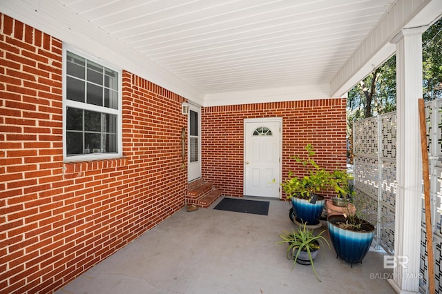 30577 Baldwin St, Perdido Beach, AL 36530 - view of exterior entry featuring brick siding and a patio