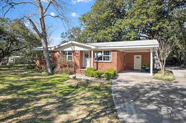 30577 Baldwin St, Perdido Beach, AL 36530 - single story home with brick siding, concrete driveway, a carport, and a front yard