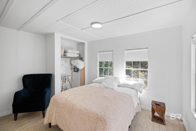30577 Baldwin St, Perdido Beach, AL 36530 - bedroom featuring wood finished floors, baseboards, and a decorative wall