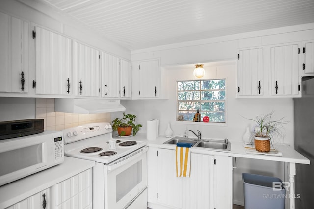 30577 Baldwin St, Perdido Beach, AL 36530 - kitchen featuring white appliances, under cabinet range hood, a sink, light countertops, and decorative backsplash
