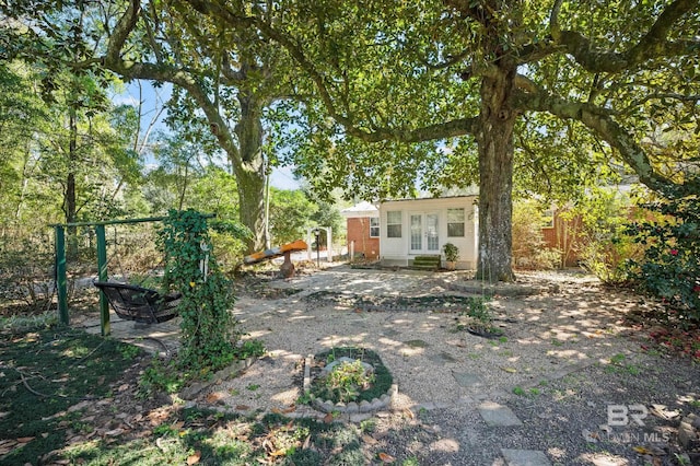 30577 Baldwin St, Perdido Beach, AL 36530 - view of yard featuring french doors and an outbuilding