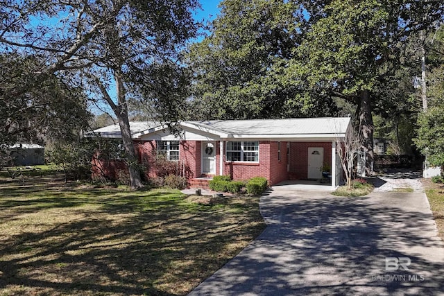 30577 Baldwin St, Perdido Beach, AL 36530 - single story home featuring concrete driveway, brick siding, an attached carport, and a front lawn