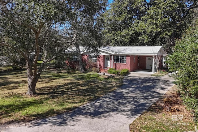 30577 Baldwin St, Perdido Beach, AL 36530 - ranch-style home with concrete driveway, an attached carport, a front lawn, and brick siding