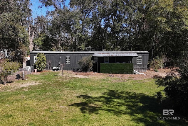 30577 Baldwin St, Perdido Beach, AL 36530 - rear view of house featuring a yard