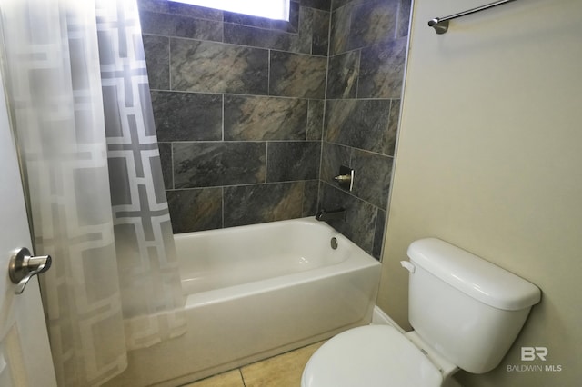 bathroom featuring tile patterned floors, shower / bath combo with shower curtain, and toilet