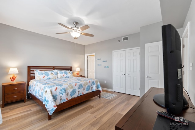 bedroom featuring ceiling fan, a closet, and light wood-type flooring