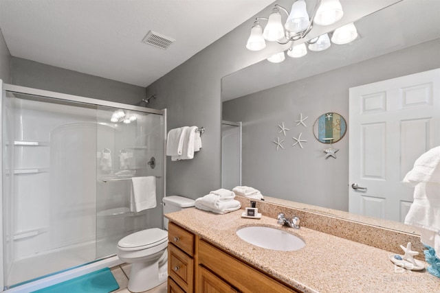 bathroom with tile patterned flooring, vanity, toilet, and an enclosed shower