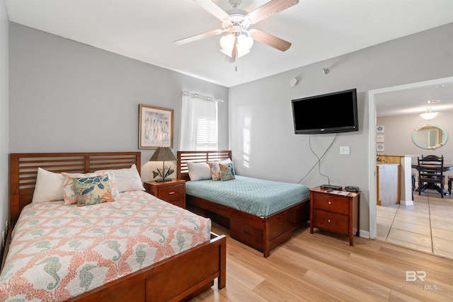 bedroom with light hardwood / wood-style flooring and ceiling fan