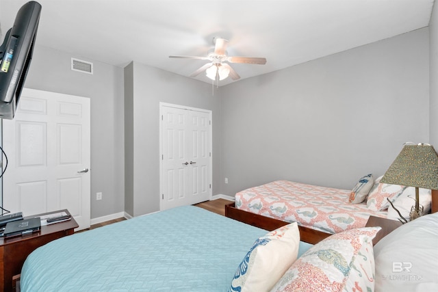 bedroom featuring ceiling fan, a closet, and hardwood / wood-style flooring