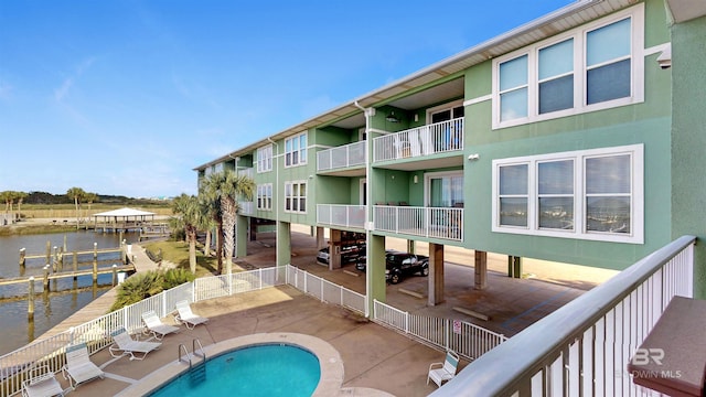 view of pool with a patio and a water view