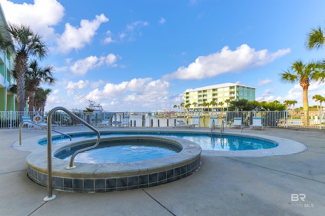 view of pool with a hot tub